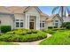 Beautiful home with a prominent columned entry and manicured green shrubbery along the front walkway at 1324 Dovercourt Ln, Ormond Beach, FL 32174