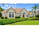 Charming home boasting a tile roof, elegant entryway, and manicured lawn with shrubbery at 1324 Dovercourt Ln, Ormond Beach, FL 32174