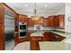 Modern kitchen with stainless steel appliances, granite countertops, and custom cabinetry at 1324 Dovercourt Ln, Ormond Beach, FL 32174
