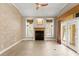 Cozy living room with a fireplace and large windows with plantation shutters at 1324 Dovercourt Ln, Ormond Beach, FL 32174