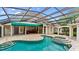 Inviting screened pool and spa surrounded by ample patio space and beautiful arches for outdoor entertaining at 1324 Dovercourt Ln, Ormond Beach, FL 32174