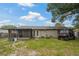 Backyard featuring green grass, a screened patio and a utility vehicle at 137 Fort Smith Blvd, Deltona, FL 32738