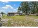 Backyard view showcasing the home's screened porch and detached shed at 137 Fort Smith Blvd, Deltona, FL 32738