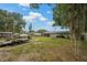 Backyard with ample space, featuring a shed, utility vehicle, and screened-in patio at 137 Fort Smith Blvd, Deltona, FL 32738