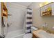 Bathroom features a tub with white tile, toilet, sink, and shelving at 137 Fort Smith Blvd, Deltona, FL 32738