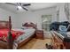 Bedroom featuring a ceiling fan, window and traditional-style furniture at 137 Fort Smith Blvd, Deltona, FL 32738