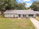Charming single-story home with a well-maintained lawn and an attached garage at 137 Fort Smith Blvd, Deltona, FL 32738