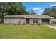 Charming single-story home with a well-maintained lawn, green door, and attached one car garage at 137 Fort Smith Blvd, Deltona, FL 32738