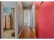 Hallway with wood floors and doors leading to various rooms at 137 Fort Smith Blvd, Deltona, FL 32738