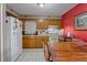 Eat-in kitchen featuring white tile flooring, oak cabinets, and a white refrigerator at 137 Fort Smith Blvd, Deltona, FL 32738