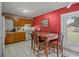 Eat-in kitchen featuring white tile flooring, oak cabinets, and a dining table at 137 Fort Smith Blvd, Deltona, FL 32738