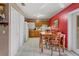 Eat-in kitchen featuring white tile flooring, oak cabinets, and a dining table at 137 Fort Smith Blvd, Deltona, FL 32738
