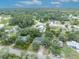 Aerial view of a charming home surrounded by lush mature trees in neighborhood at 1398 5Th Ave, Deland, FL 32724