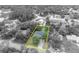 Monochromatic aerial view of home; lush neighborhood of mature trees at 1398 5Th Ave, Deland, FL 32724