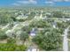 An aerial view features this home in a mature and verdant neighborhood with tree-lined streets at 1398 5Th Ave, Deland, FL 32724