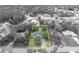 A black and white aerial view of the house surrounded by mature trees at 1398 5Th Ave, Deland, FL 32724