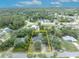 Aerial view of a charming home with mature trees in a lush neighborhood at 1398 5Th Ave, Deland, FL 32724