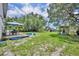 Spacious backyard featuring a deck, play area, and lush greenery at 1398 5Th Ave, Deland, FL 32724