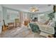 Cozy primary bedroom with a ceiling fan, sitting area, and ample natural light at 1398 5Th Ave, Deland, FL 32724