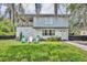 Two story home with a balcony, landscaped lawn, and outdoor seating in the front yard at 1398 5Th Ave, Deland, FL 32724