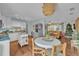 Open kitchen with white cabinetry, island, and dining area adjacent to living room at 1398 5Th Ave, Deland, FL 32724