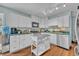 Well-lit kitchen featuring an island, stainless steel appliances, and ample countertop space at 1398 5Th Ave, Deland, FL 32724