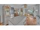 Bright kitchen area with stainless steel refrigerator, kitchen island, and view into living space at 1398 5Th Ave, Deland, FL 32724