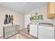 Functional laundry room equipped with a washer, dryer, and storage shelving at 1398 5Th Ave, Deland, FL 32724