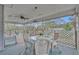 Covered porch with wicker furniture and a glass-top table, perfect for outdoor relaxation at 1398 5Th Ave, Deland, FL 32724