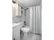 Cozy bathroom featuring white subway tiles, stylish fixtures, and a decorative shower curtain at 1402 E Voorhis Ave, Deland, FL 32724