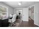 Well-lit office space with dark floors, ceiling fan, and natural light from a large window at 1402 E Voorhis Ave, Deland, FL 32724