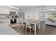 An open floor plan shows the dining room adjacent to a modern kitchen at 1402 E Voorhis Ave, Deland, FL 32724