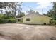 Back exterior showing parking with a fenced yard, showcasing a well-kept property with ample outdoor space at 1402 E Voorhis Ave, Deland, FL 32724