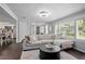 Comfortable living room with a sectional sofa and views into the kitchen at 1402 E Voorhis Ave, Deland, FL 32724