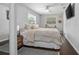 Comfortable main bedroom featuring a ceiling fan and hardwood floors at 1402 E Voorhis Ave, Deland, FL 32724