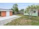 Fenced backyard with two sheds, patio, and small trees at 1411 Cliff Ave, Eustis, FL 32726