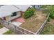 Aerial view of fenced backyard with patio, and yellow house at 1411 Cliff Ave, Eustis, FL 32726