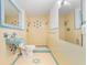 Bathroom featuring yellow tile, retro fixtures, and a walk in shower at 1411 Cliff Ave, Eustis, FL 32726