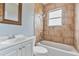 Bathroom with tub and shower, vanity, toilet and tiled walls at 1411 Cliff Ave, Eustis, FL 32726