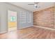 Bedroom with wooden floors, an accent wall, built in shelves, and a ceiling fan at 1411 Cliff Ave, Eustis, FL 32726
