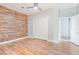 Bedroom featuring wood flooring, closet, accent wall, and ceiling fan at 1411 Cliff Ave, Eustis, FL 32726