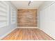 Bedroom featuring wood flooring, closet, accent wall, and built-in shelves at 1411 Cliff Ave, Eustis, FL 32726