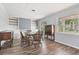 Dining area featuring built-in shelving, wood floors, and natural light from the window at 1411 Cliff Ave, Eustis, FL 32726