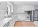 Well-lit kitchen features stainless steel refrigerator, range, tiled backsplash, and ample cabinet space at 1411 Cliff Ave, Eustis, FL 32726