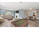 Open-concept living room featuring fireplace, hardwood floors, and dining and sitting areas at 1411 Cliff Ave, Eustis, FL 32726