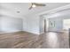Spacious living room featuring light-gray walls, wood flooring, and plenty of natural light with ceiling fan at 1411 Cliff Ave, Eustis, FL 32726