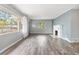 Bright living room with hardwood floors, large windows and decorative fireplace at 1411 Cliff Ave, Eustis, FL 32726