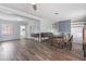 Spacious living area with a dining set, built-in shelves, and wood flooring for comfortable living at 1411 Cliff Ave, Eustis, FL 32726