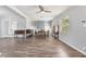 Living area featuring dining set, built-in shelving, wood flooring and natural light at 1411 Cliff Ave, Eustis, FL 32726