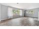 Bright living room with hardwood floors, large windows, and an open floor plan at 1411 Cliff Ave, Eustis, FL 32726